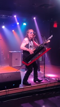 a man playing a keyboard on stage