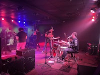 a group of people playing music in a dark room