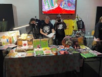 a group of people standing around a table