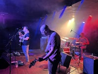 a group of people playing music on stage
