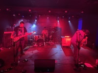 a group of people playing music in a dark room