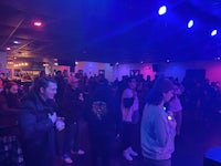 a crowd of people standing in a dark room